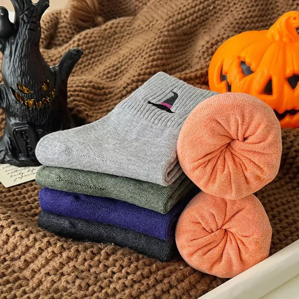 Close-up of embroidered Halloween motifs on knit socks