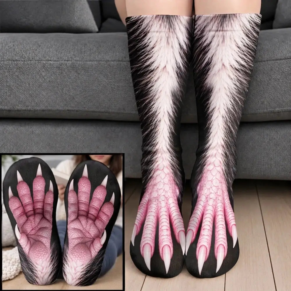 White and pink furry monster claw socks with pink webbed toes worn on legs before a gray sofa