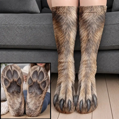 Gray brown wolf fur paw socks with dark claws worn on legs before a gray sofa