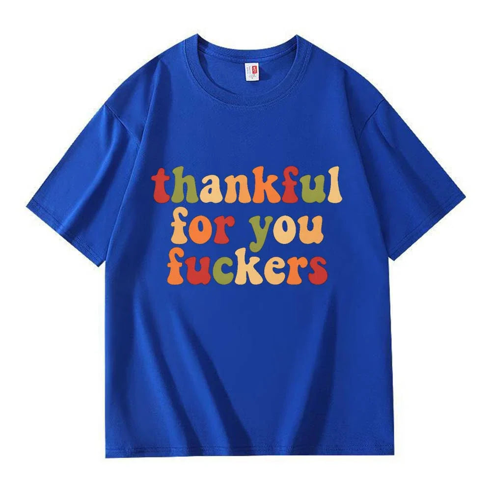A royal blue crew neck T-shirt with three lines of retro multicolor Thanksgiving lettering on a white background