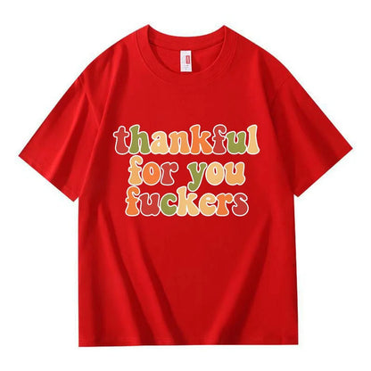 A red crew neck T-shirt with three lines of colorful retro Thanksgiving lettering on a white background