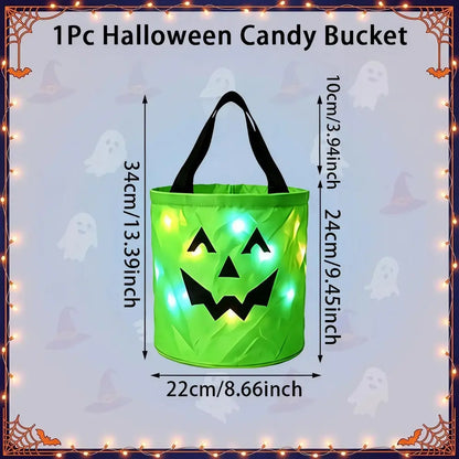 A green inflatable Halloween candy bucket with black handles and a jack-o'-lantern face, shown with overlaid dimensions (34 cm tall, 22 cm wide) and a lighted glow effect. The image includes the text '1Pc Halloween Candy Bucket' and a decorative Halloween border with ghosts and spiderwebs.