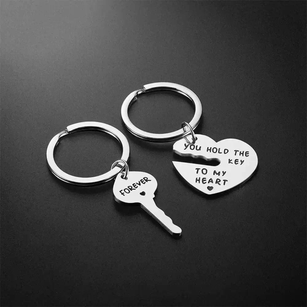 Two silver keychain pendants on a black background