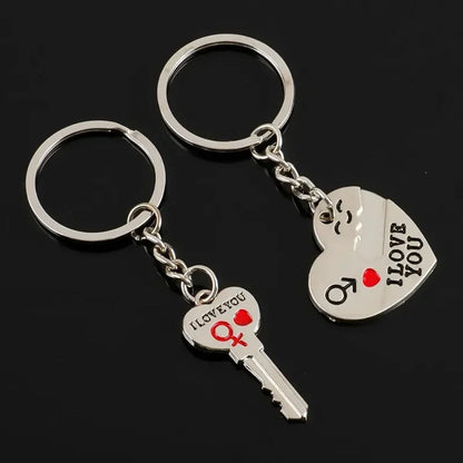 Two silver key-shaped keychains with 'I LOVE YOU' text on a black background