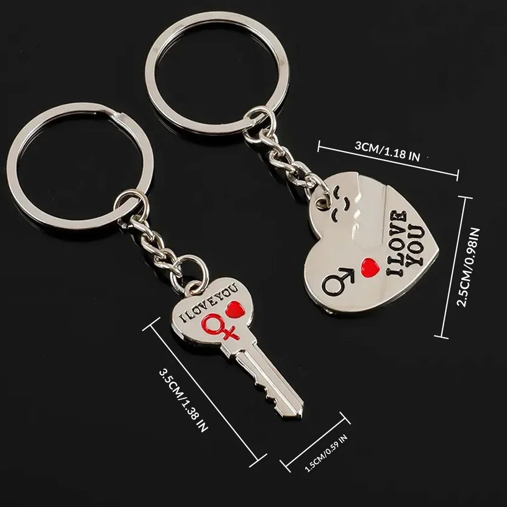 Two silver metal keychains on a black background, one with a key-shaped charm and one with a heart-shaped charm, both printed with 'I LOVE YOU' and gender symbols. 