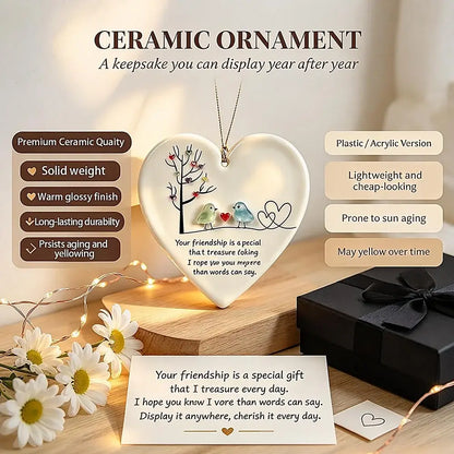 Heart-shaped ceramic keepsake ornament displayed on a wooden surface with a necklace, surrounded by daisies, fairy lights, a gift box, and informational text bubbles describing product features.