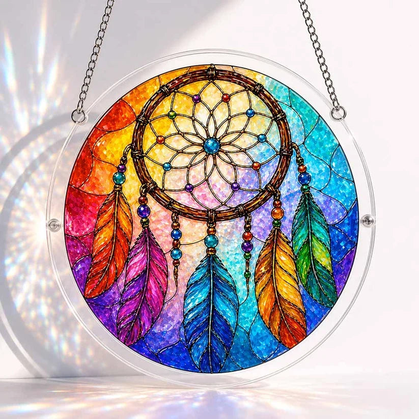 A round acrylic suncatcher with a beaded rainbow dreamcatcher and multicolored feathers on a gradient background