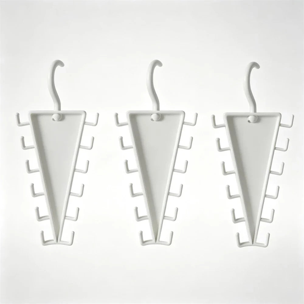 Three white triangular wall hooks with multiple small side hooks, shown on a plain light background.