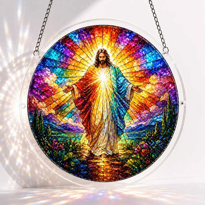 A round acrylic suncatcher depicting a radiant Jesus figure with open arms surrounded by rainbow light clouds and mountains