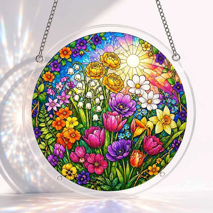 A round acrylic suncatcher filled with colorful spring tulips daffodils roses and lilies under a bright sun