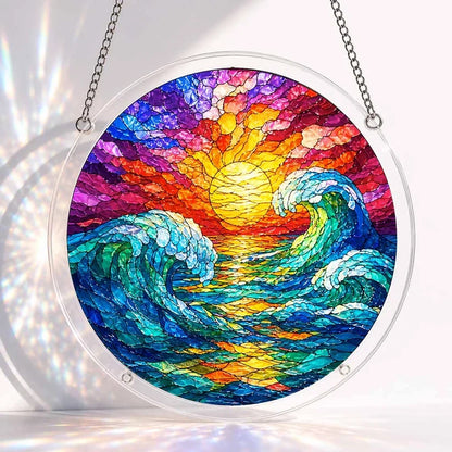 A round acrylic suncatcher with two curling turquoise waves beneath a golden sun over a colorful ocean sunset