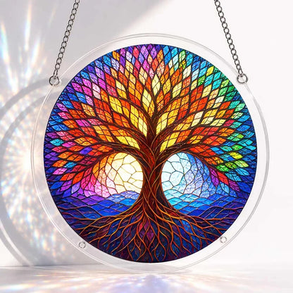 A round acrylic suncatcher featuring a symmetrical rainbow tree of life with intricate roots and multicolor foliage